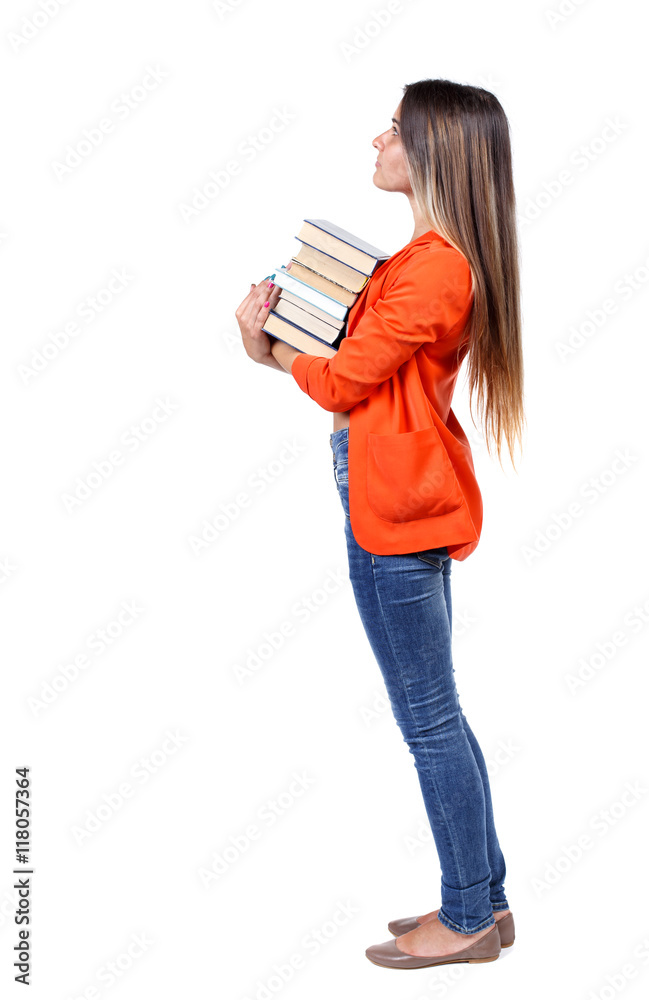 Girl carries a heavy pile of books. back view. Rear view people collection. backside view of person. Isolated over white background. girl in a red jacket stands sideways with a stack of books and Girl carries a heavy pile of books. back view. Rear view people collection. backside view of person. Isolated over white background. girl in a red jacket stands sideways with a stack of books and