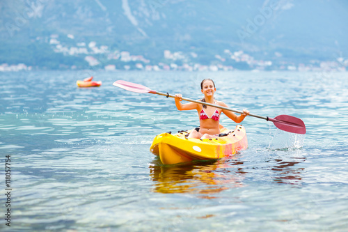 Girl enjoying paddling in kayak on the sea water  © Mediteraneo