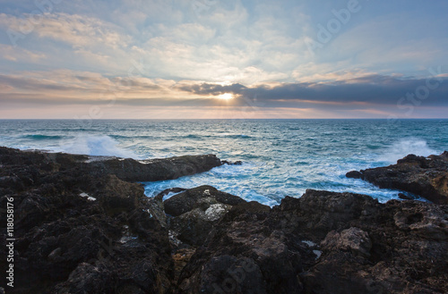 Evening seascape view from rocky shore.