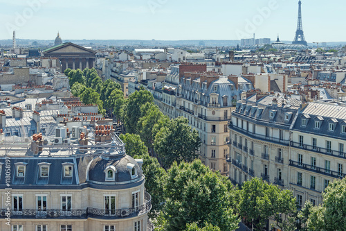 Panorama of Paris. View from gallery Printemps. Paris rooftops and view on eiffel tower. Beautiful view of the rooftops and street on a sunny day. France.
