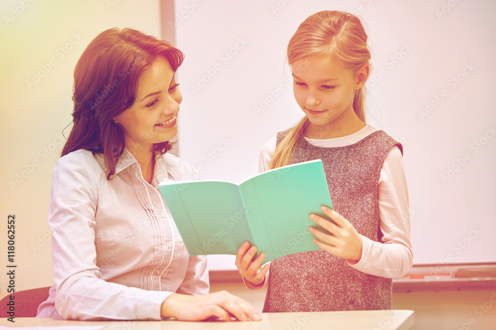 school girl with notebook and teacher in classroom school girl with notebook and teacher in classroom