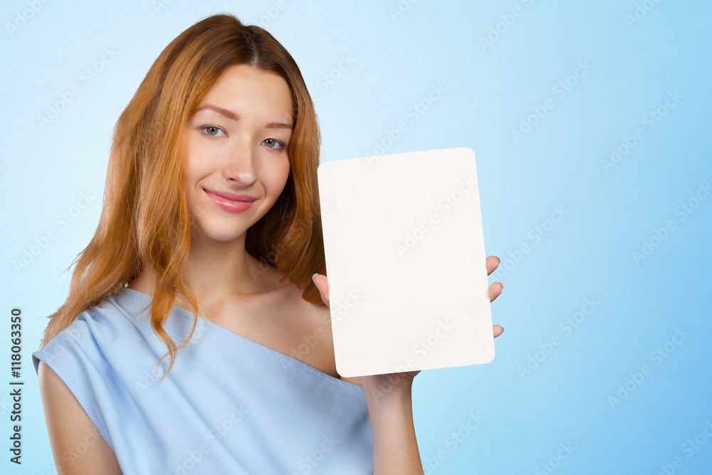 Cheerful attractive young woman showing blank sheet of paper with copy space Cheerful attractive young woman showing blank sheet of paper with copy space