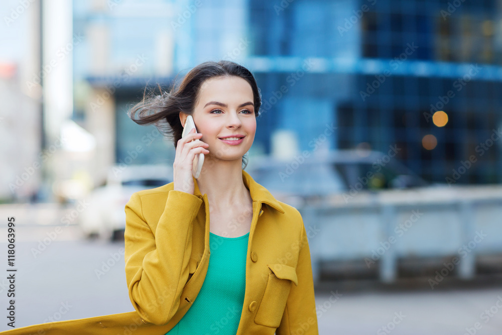 Fototapeta premium smiling young woman or girl calling on smartphone