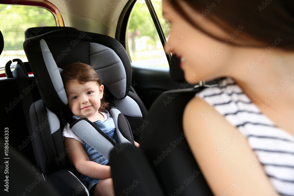 Mother and child in car. Safety driving concept