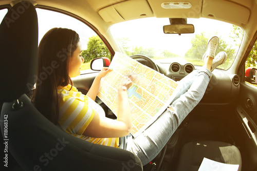 Woman sitting with road map...