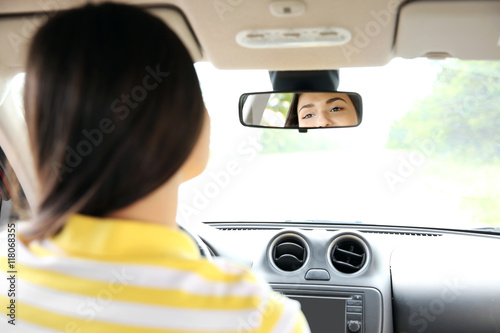 Woman looking at mirror in ...