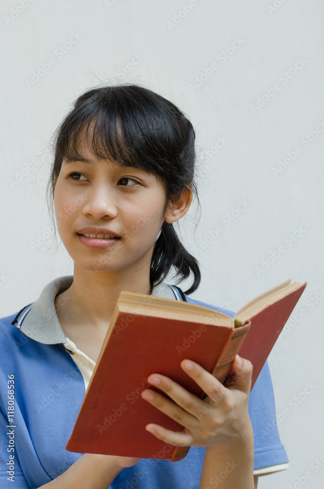 Asian Teenager Girl Thinking When Reading A Book. Asian Teenager Girl Thinking When Reading A Book.