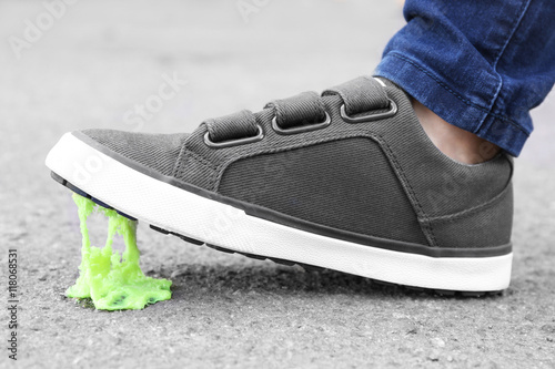 Foot stuck into chewing gum on street