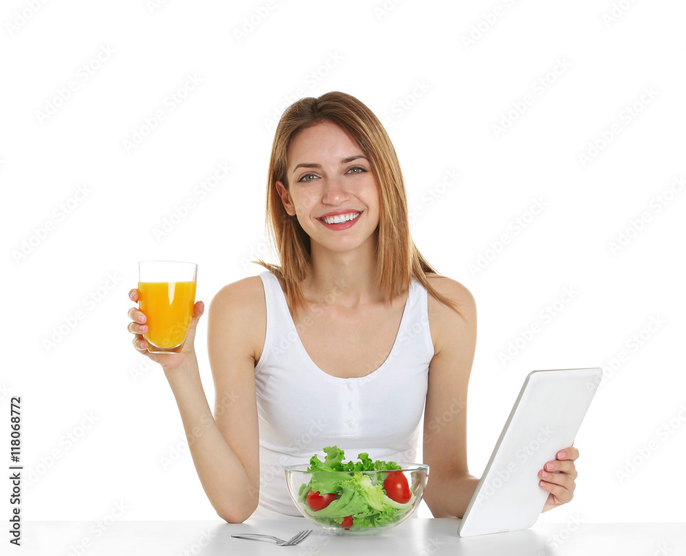 Woman with tablet and healthy food on white background Woman with tablet and healthy food on white background