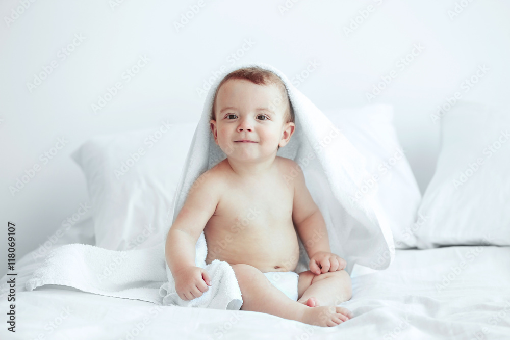 Cute baby sitting on the bed Cute baby sitting on the bed