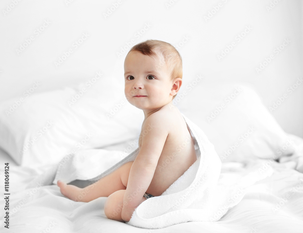 Cute baby sitting on the bed Cute baby sitting on the bed