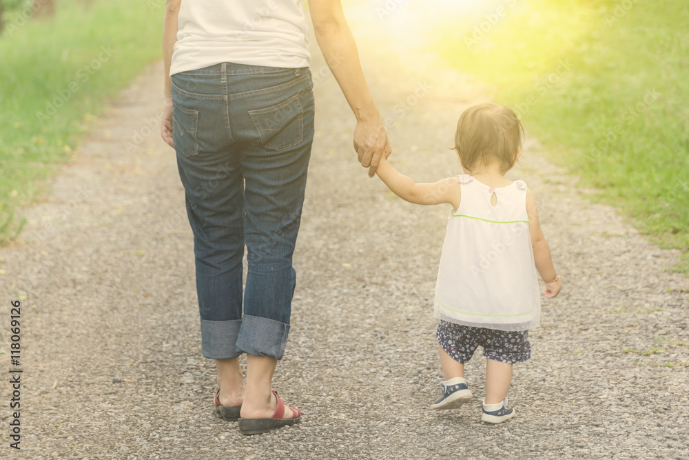 Mom holding hands with her daughter,Concept for mother day Mom holding hands with her daughter,Concept for mother day
