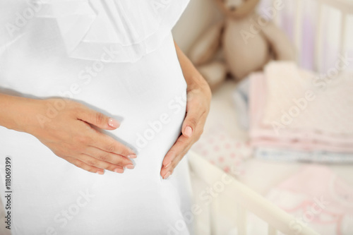 Pregnant woman near baby cr...