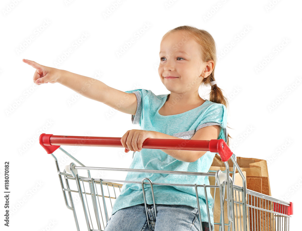 Cute girl sitting in shopping cart with pack of products on white ...