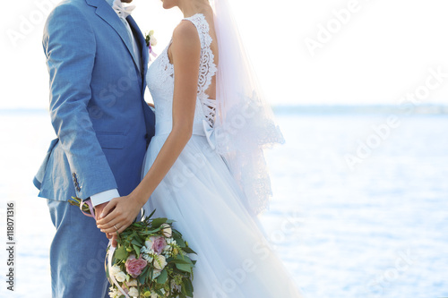 Happy wedding couple on riv...