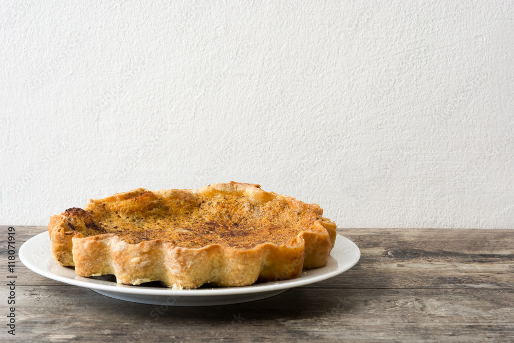 Homemade pumpkin pie on wooden background
Homemade pumpkin pie on wooden background