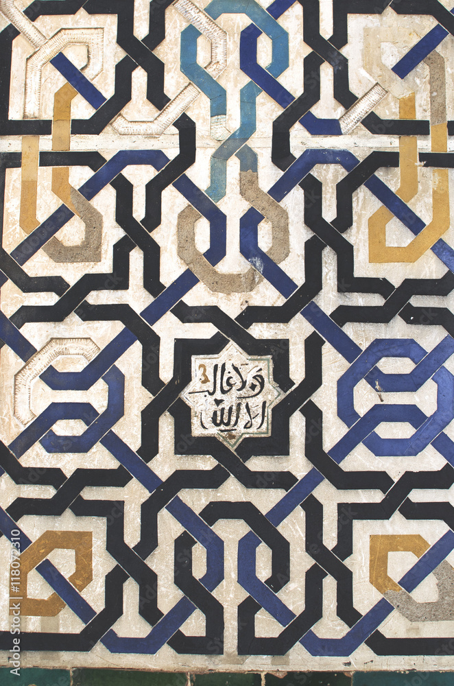 Moorish pattern from Alhambra, Granada, Spain - Closeup of a plaster wall with islamic floral motif Moorish pattern from Alhambra, Granada, Spain - Closeup of a plaster wall with islamic floral motif
