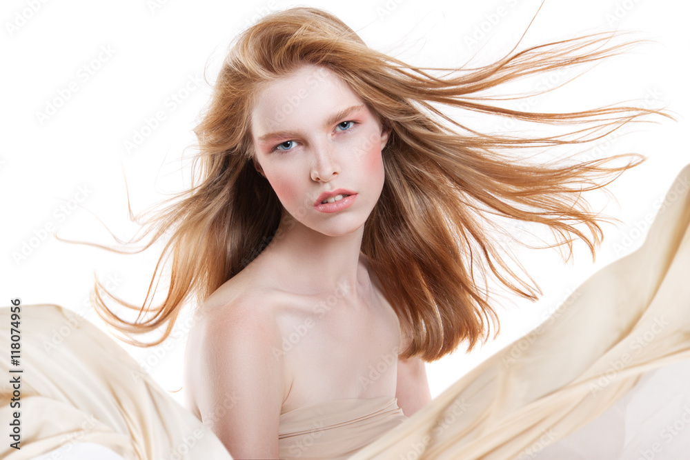 Fototapeta premium beautiful young woman with flying hair. Red hair flying in the wind.