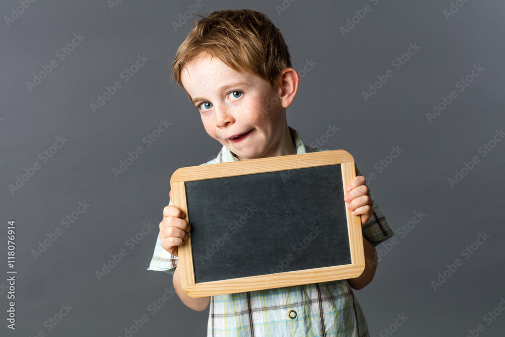 cheeky kid showing an empty writing slate for school learning cheeky kid showing an empty writing slate for school learning