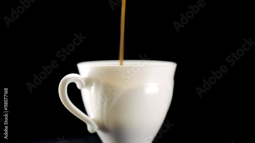 Coffee pouring into white cup photo