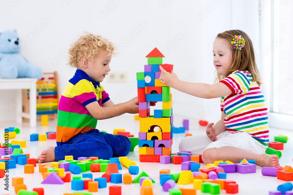 Kids playing with colorful toy blocks Kids playing with colorful toy blocks