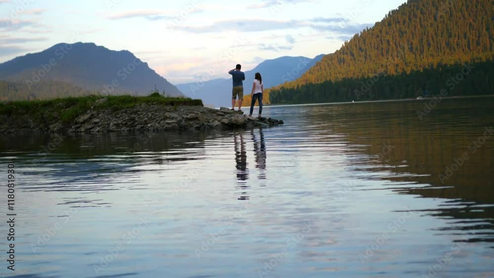 love couple walking on river at sunset love couple walking on river at sunset