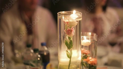 Decorative table setting pan with candle lights at a wedding reception. 1080p HD.
