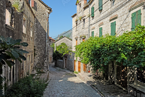 Fototapeta Naklejka Na Ścianę i Meble -  Typical narrow street in town of Risan, Montenegro