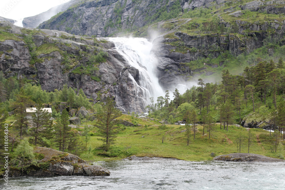 Fototapeta premium Waterfall in Husedalen valley in Hardangervidda national park, Norway 