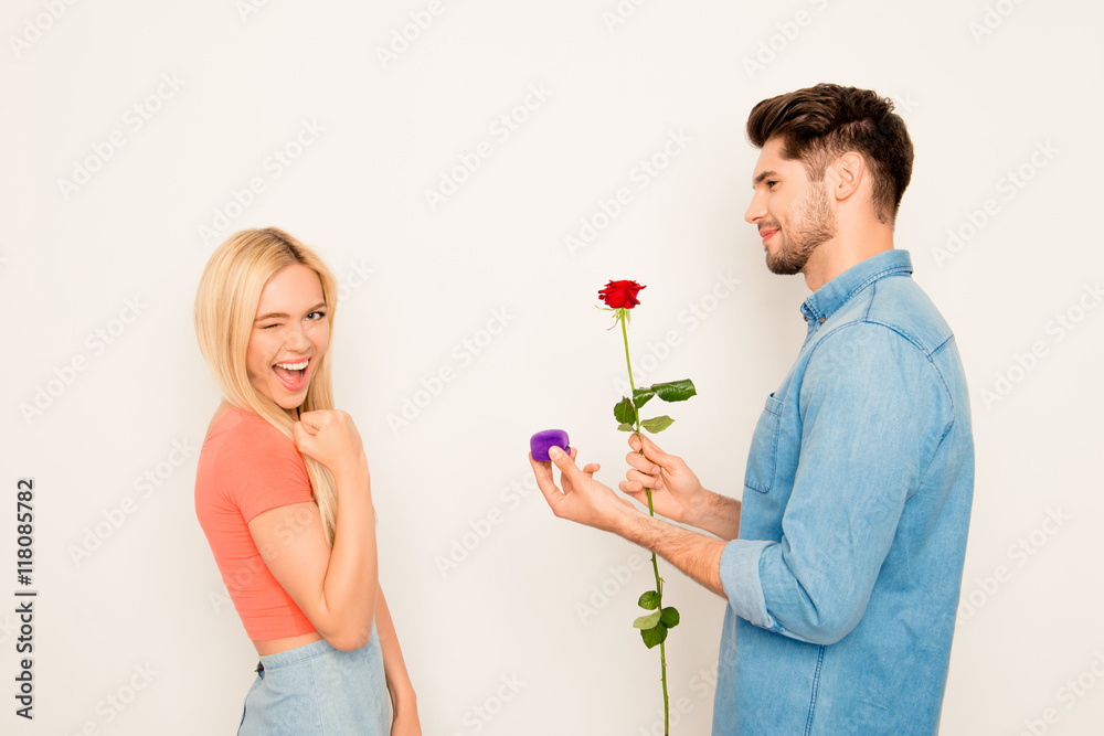Portrait of happy woman and man holding rose and box with weddin Portrait of happy woman and man holding rose and box with weddin