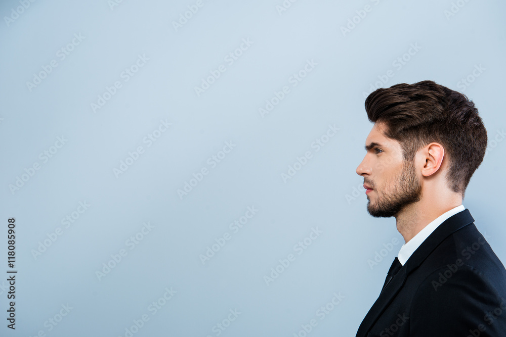Side view of serious businessman isolated on gray background Side view of serious businessman isolated on gray background