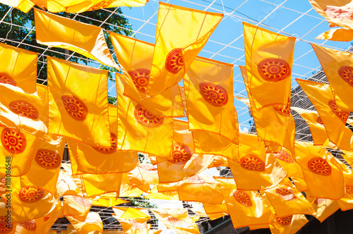 Thammachak flag yellow in temple (Wat Phan tao) on blue sky temple Northern Thailand photo