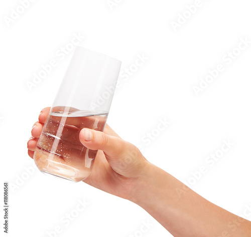Female hand holding drinking glass with water against white