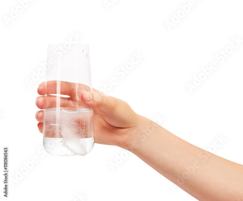 Hand holding glass with white effervescent tablet in water © IntelWond
