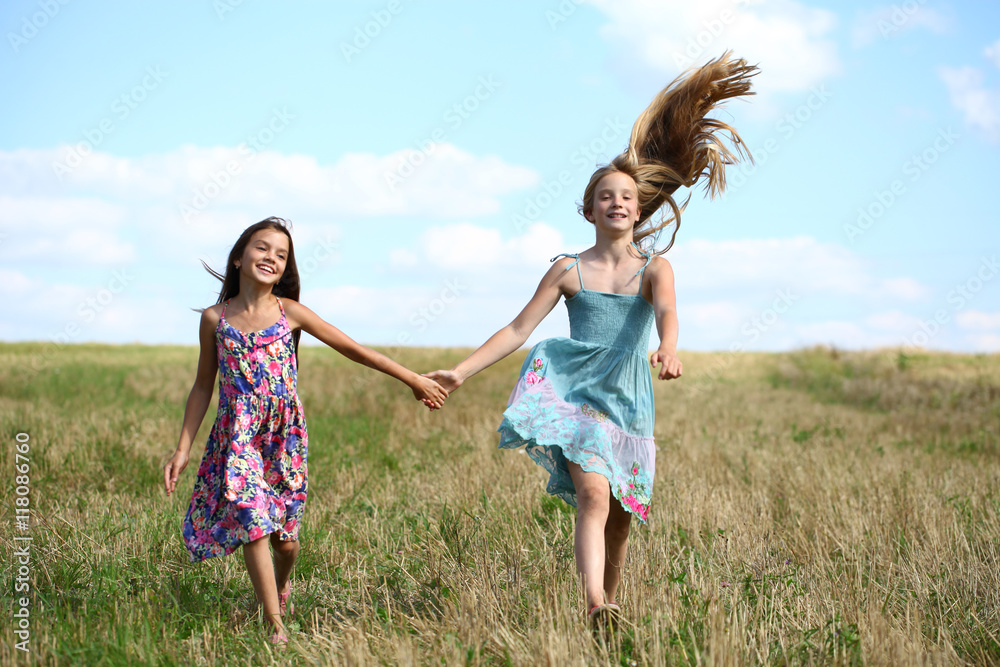 Two little girls running in summer field Two little girls running in summer field