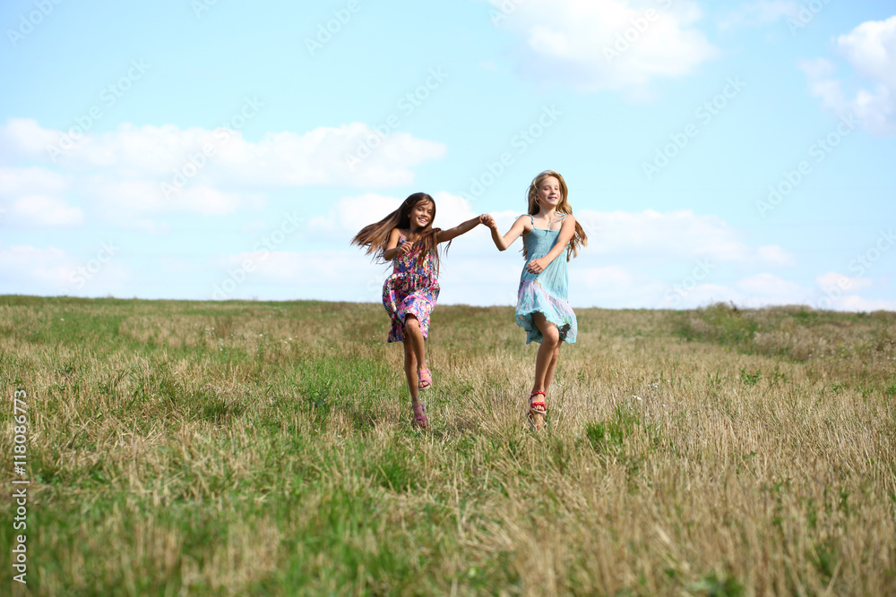 Two little girls running in summer field Two little girls running in summer field