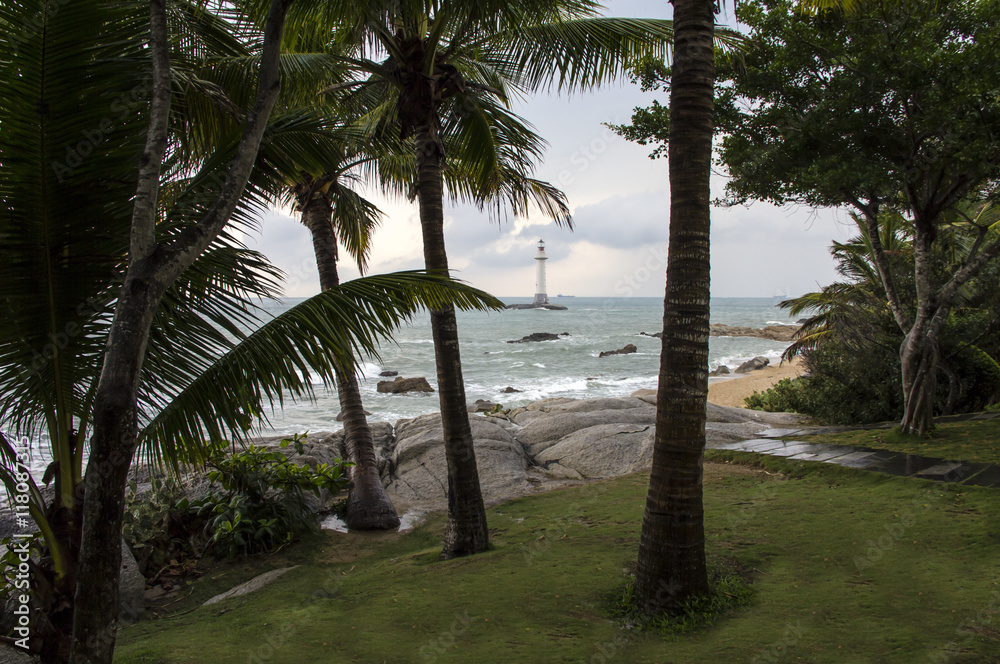View of a lighthouse in the Dongtian park, Sanya, Hainan, China and palm trees View of a lighthouse in the Dongtian park, Sanya, Hainan, China and palm trees