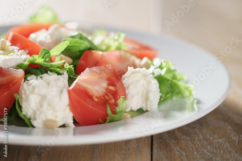 salad with tomatoes, mozzarella, rocket salad and cedar nuts