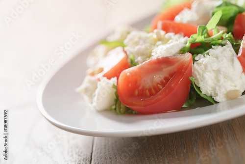 salad with tomatoes, mozzarella, rocket salad and cedar nuts