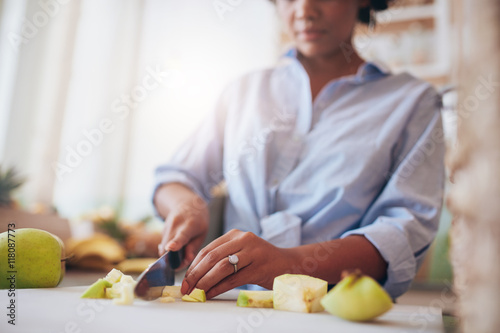 Female hands chopping fruits for juice