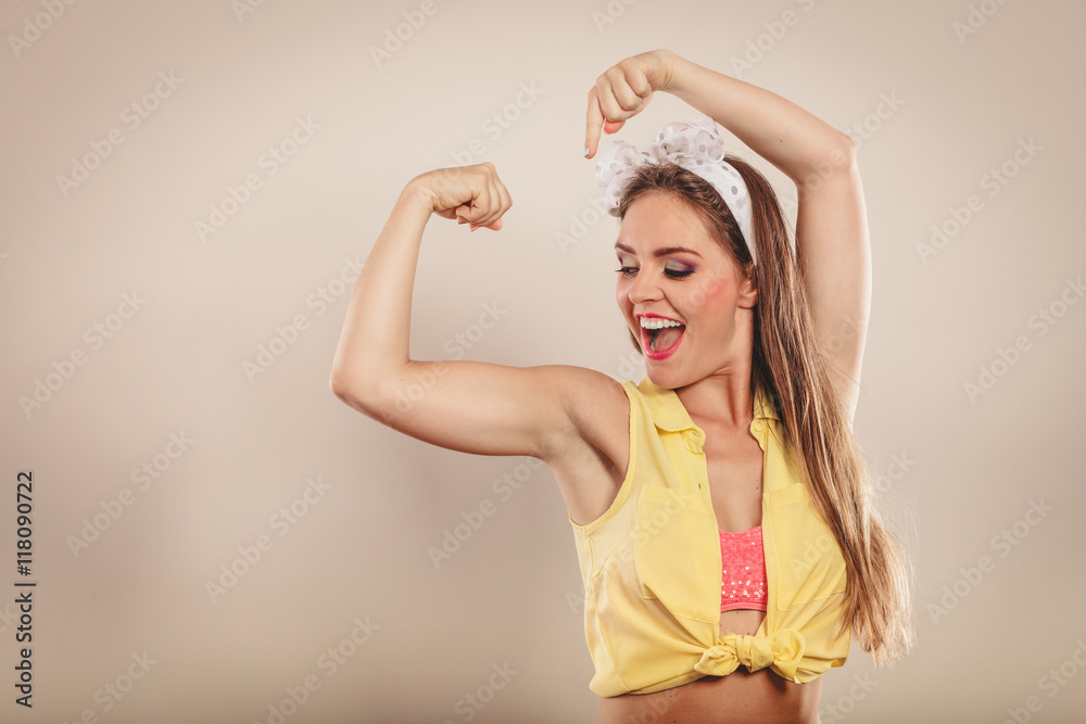Happy pretty pin up girl showing off muscles. Happy pretty pin up girl showing off muscles.