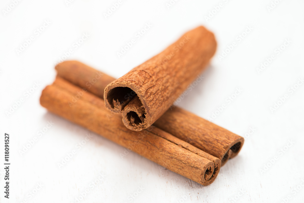 cinnamon sticks on white board cinnamon sticks on white board