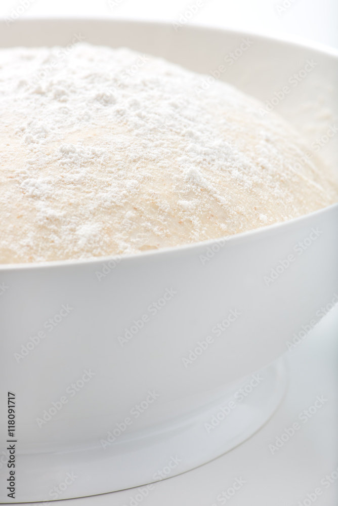 fresh, handmade, uncooked pizza or bread dough in a white bowl fresh, handmade, uncooked pizza or bread dough in a white bowl