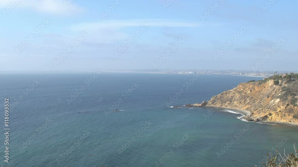 Los Angeles beach cities coastline shot from a viewpoint in Palos Verdes, clear blue sky on a sunny day and deep blue ocean with lots of waves Los Angeles beach cities coastline shot from a viewpoint in Palos Verdes, clear blue sky on a sunny day and deep blue ocean with lots of waves