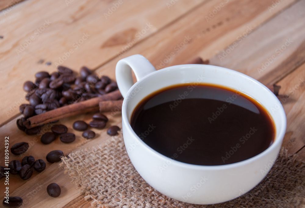 Hot coffee and coffee bean on wooden background Hot coffee and coffee bean on wooden background