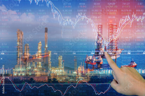 Stock market concept with oil rig in the gulf and oil refinery industry background,Double exposure