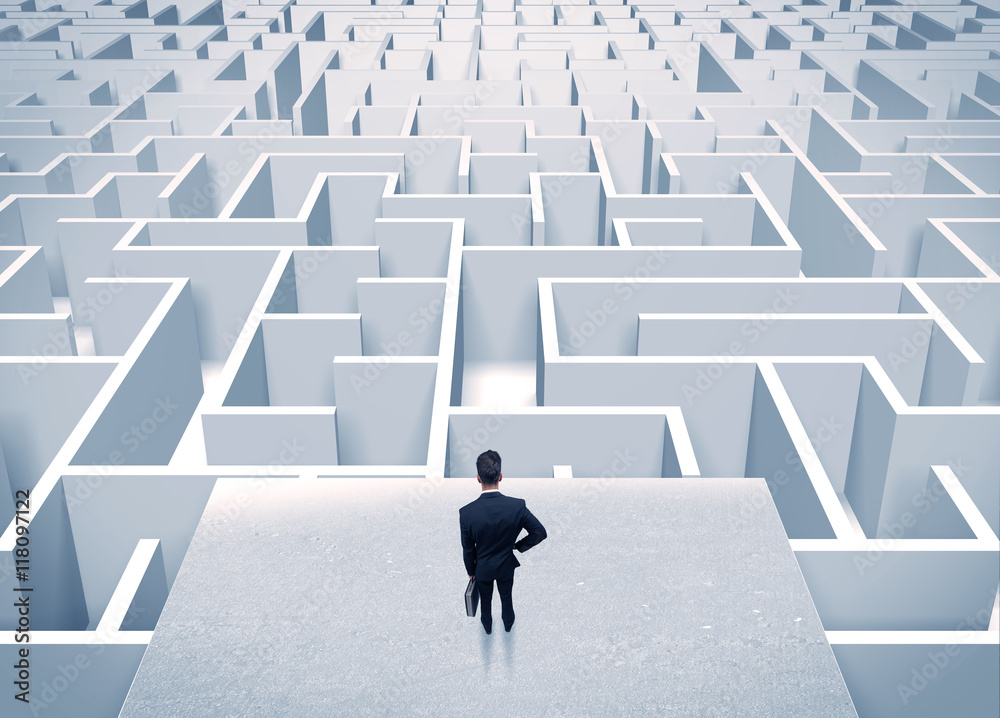 Businessman staring at infinite maze Businessman staring at infinite maze