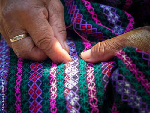 old woman's hand sewing on crafting cloth