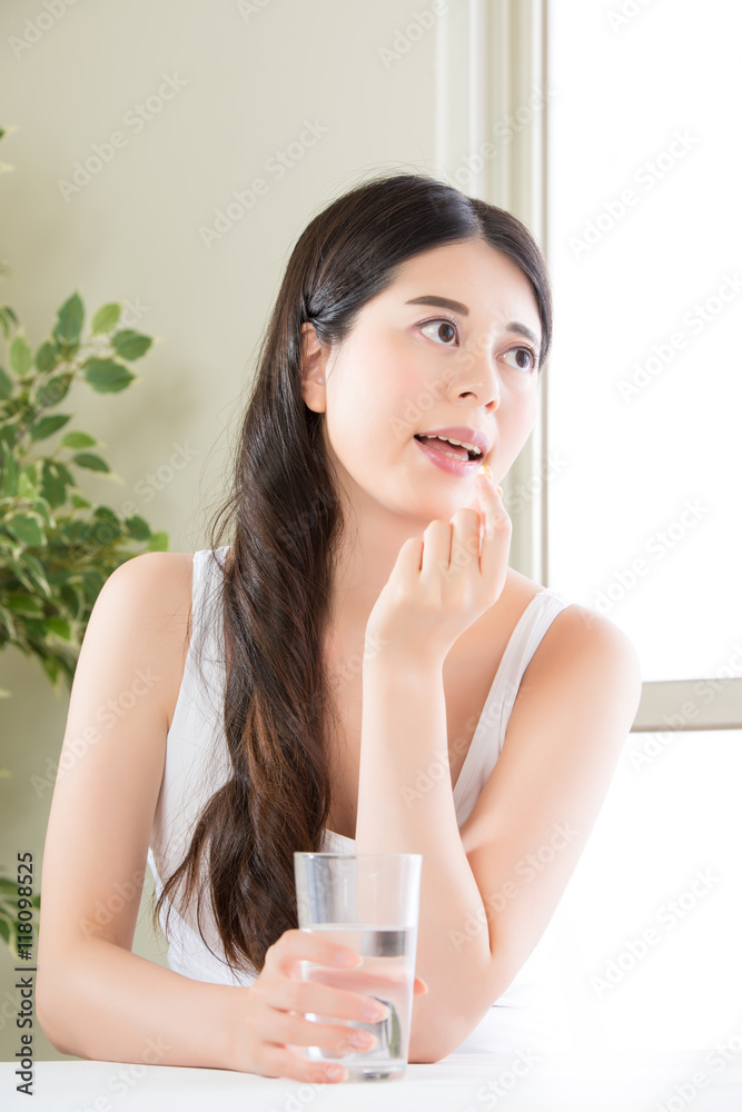 beautiful asian women eating vitamin pill for health care beautiful asian women eating vitamin pill for health care