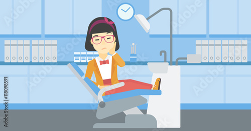 Woman suffering in dental chair.